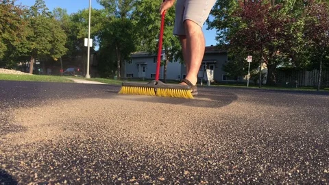 Man Sweeping with Push Broom Stockbeeldmateriaal 79630319