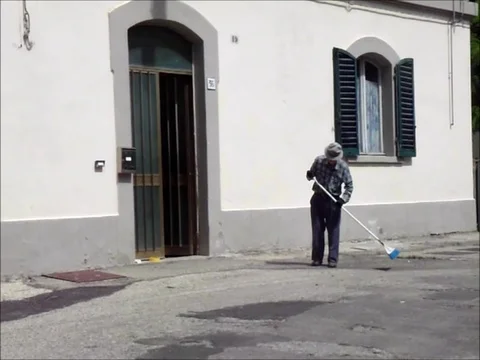 Man sweeps in front of the small station Stock Footage 118403683