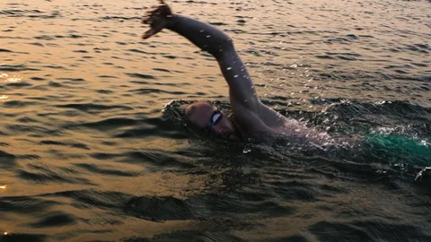 Man swimmer at morning sea. swimming athlete triathlon swim training Stock Footage