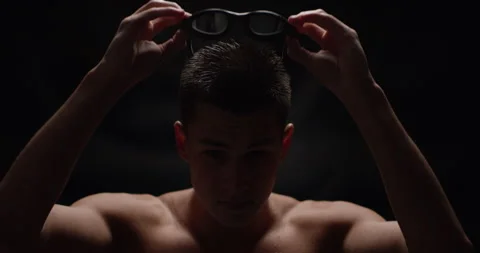 Man swimmer putting his goggles on Stock Footage 283039660