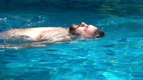 Man swimming on the back in the pool, slow motion shot at 240fps  Stock Footage 88540389