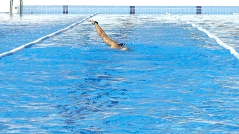 Man swimming in a deep blue pool Stock Footage 202650211