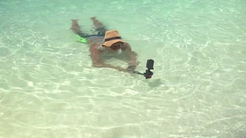 Man swimming face down in clear shallow tropical beach water Video stock 341953605