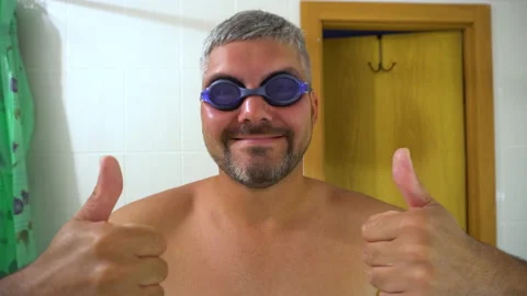 Man in swimming goggles shows class 4K Video stock 156772253
