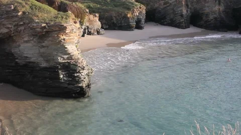 Man swimming in an idyllic beach Stock Footage 214085805