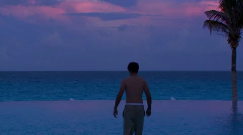 Man swimming in infinity pool Stock Footage 54593050