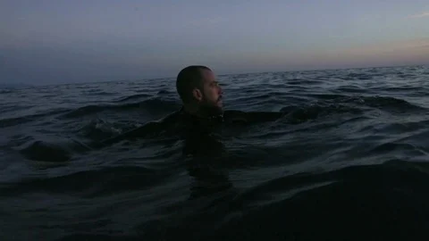 Man swimming lost in Sea Stock Footage