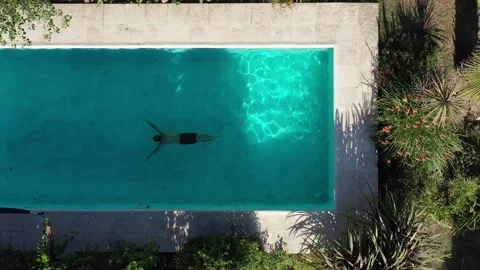 Man swimming in pool at a bead and breakfast Stock Footage 255862020