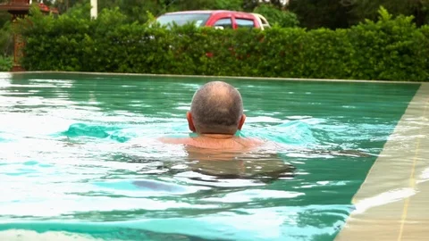 The man is swimming in the pool Stock Footage 94040456