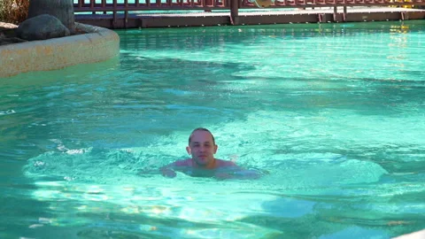 Man swimming in pool in slow motion 180fps Stock Footage 105055929