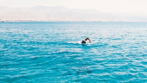 The man is swimming by the sea Stock Footage