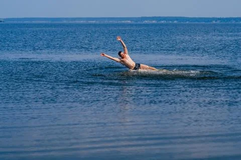 Man swims and having fun resting in water with the spray in summer Stock Photos