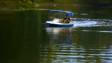 A man swims on a catamaran on the pond Stock Footage