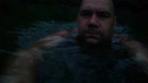 Man swims at night in the river Stock Footage 65840954