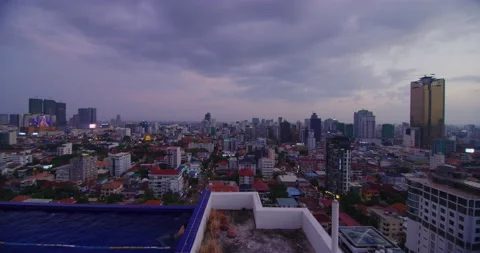 A Man Swims With The Phnom Penh Skyline In Phnom Penh, Cambodia Stock Footage 151185233