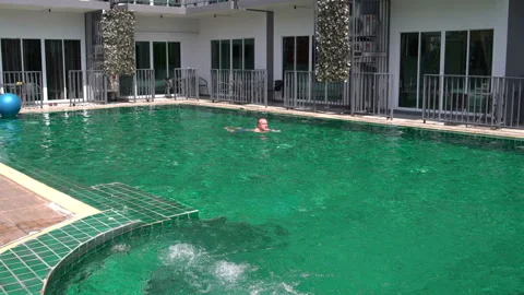 Man swims in the pool in hotel Stock Footage 91712288