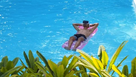 A man swims in the pool VR headset. Stock Footage 122767944