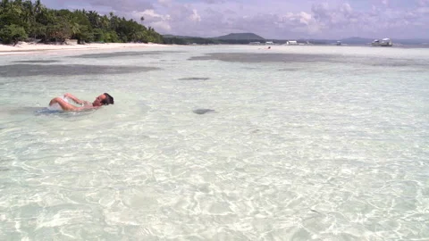 Man swims in the sea on the back Stock Footage 91369724