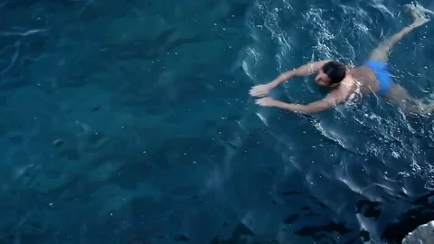 A man swims in the sea. Stock Footage 81017024