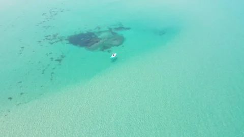 Man swims on a sup board on clear transparent water top view. Stock Footage 311500591