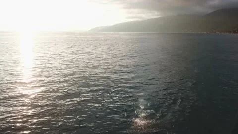 A man swims under the sunset. Stock Footage 148656786