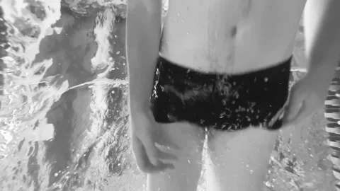Man swims underwater in the pool. Shooting a video underwater as a male swims in Stock Footage 246765400