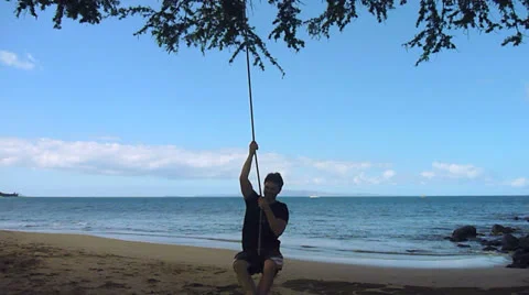 Man on Swing at Beach Time Lapse Stock Footage 23415055