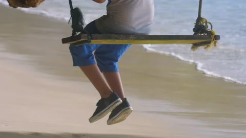 Man on a swing by the sea Stock Footage 170327948