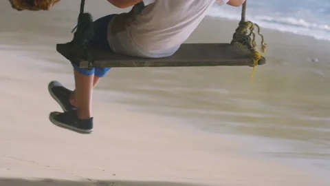Man on a swing by the sea Stock Footage 170786251