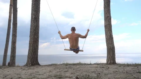 Man on a swing in slow motion Stock Footage 201029091
