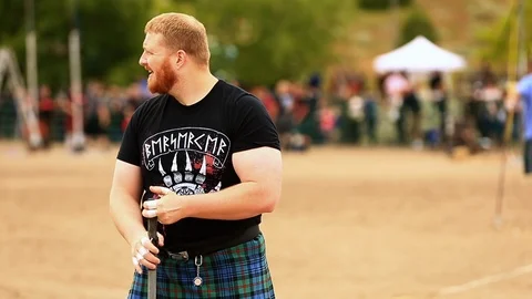 Man Swinging and Throwing Hammer at Celtic Games Stock Footage 117958813