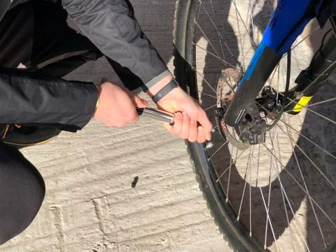 Man swinging bike's wheel using pump close-up. Cycling. Sport Stock Photos