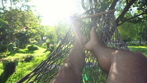 A man swinging in a hammock Stock Footage 97106574