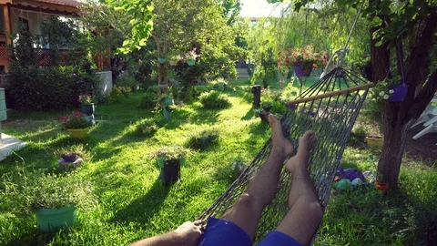 A man swinging in a hammock Stock Footage 97107182