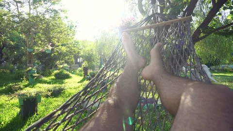 A man swinging in a hammock Stock Footage 97107248