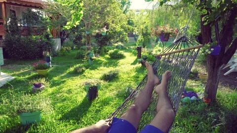 A man swinging in a hammock Stock Footage 97107702