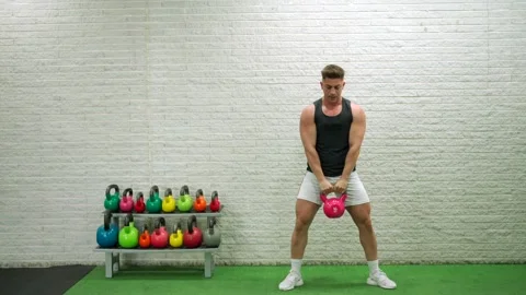 Man Swinging A Kettlebel In A Gym Stock Footage 197571853