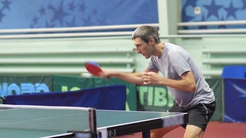 A man is swinging a racket at a ball Stock Footage 124217278