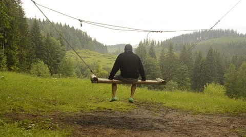 Man swinging on a swing Stock Footage 24770087
