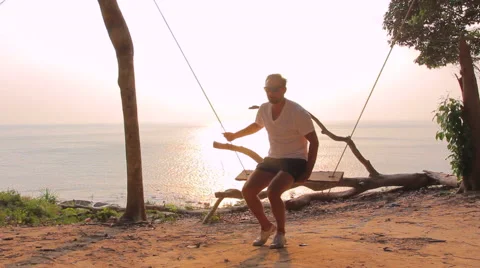 A man swinging on a swing Stock Footage 64207322