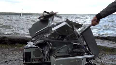 Man swings sledge hammer into printer, compuer and monitor on nature background 動画素材 92325183