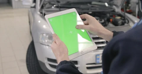 The Man Swipe The Tablet With Green Screen. Car Service Background Video stock 125010559