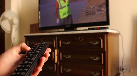 Man switch channels on the TV remote control Stock Footage 65301952