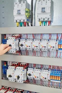 Man switch switch protection engine to check in the electrical Cabinet. Stock Photos