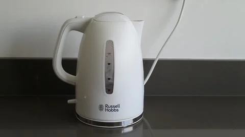 Man switches on kettle, kettle boils then switches off. With sound. Stock Footage 244925373