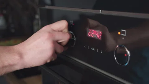 Man switches modes on the oven panel, a man's hand turns the oven switch on Stock Footage 161376522