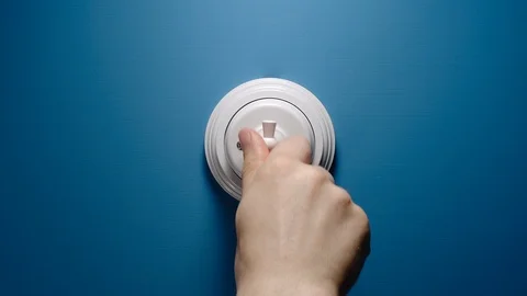 Man Switches On A Toggle Switch On The Blue Wall Видео 110774548