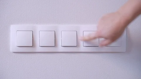 Man switching on and off the light switch on the wall 스톡 동영상 121910984