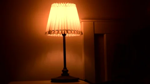 Man switching off a bedside table light before sleeping Stock Footage 134888578