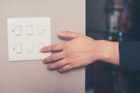 Man switching on lights Photos
